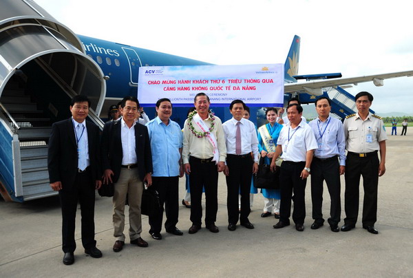Ông Phạm Văn Tài (giữa) là hành khách thứ 6 triệu qua Cảng hàng không quốc tế Đà Nẵng.