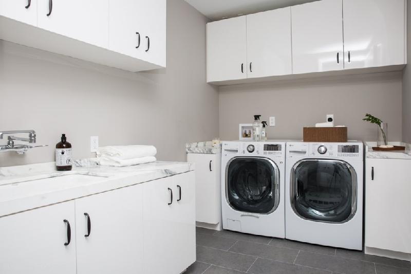 Phòng giặt ủi với tủ đồ, một máy giặt và một máy sấy đồ.