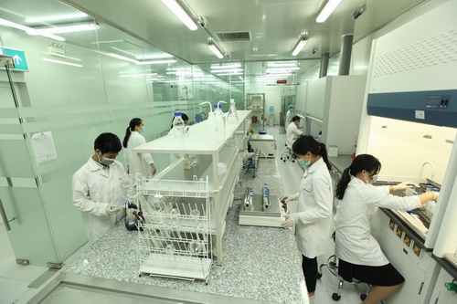 Các kiểm nghiệm viên đang thực hiện công đoạn chuẩn bị mẫu để phân tích trên thiết bị.