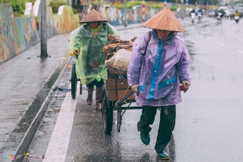 Những cảnh đời mưu sinh trong mưa lạnh hình ảnh 8 Hai người phụ nữ làm cửu vạn oằn mình kéo hàng trên đường Hồng Hà.