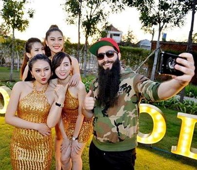Anh vui vẻ chụp hình với các cô gái xinh đẹp khi đến tham quan một dự án ở quận 7.