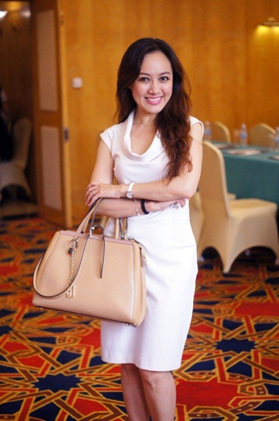 Ở một hoàn cảnh khác, Hoài Anh thả tóc và diện váy ngắn màu trắng kem cổ trễ kết hợp với túi big size màu be. Toàn thể trang phục tuy đơn giản nhưng lại mang đến cho cô vẻ nữ tính.