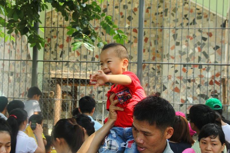 Nhiều ông bố phải kiệu con trên vai tránh dòng người đông đúc.
