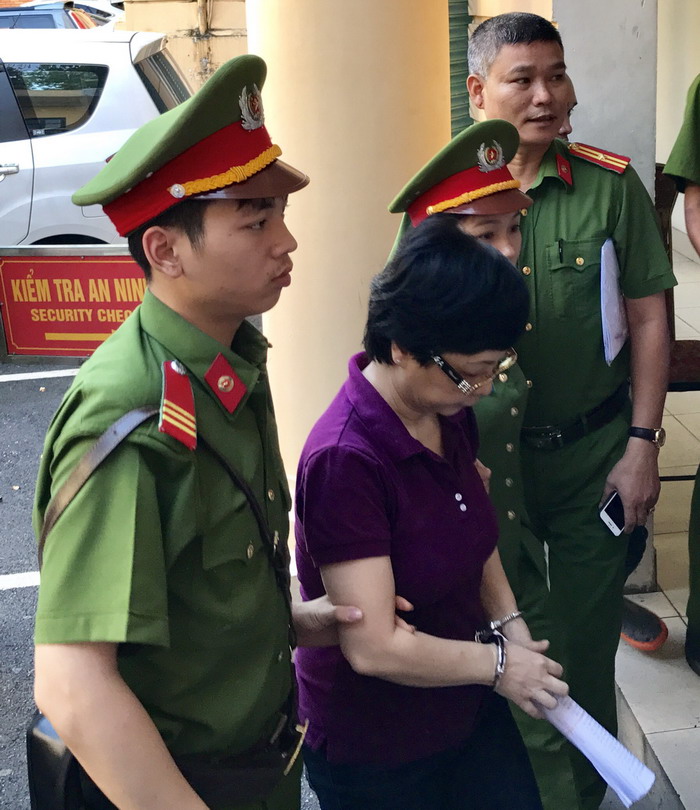 Nữ bị cáo mặc áo màu tím, quần màu....