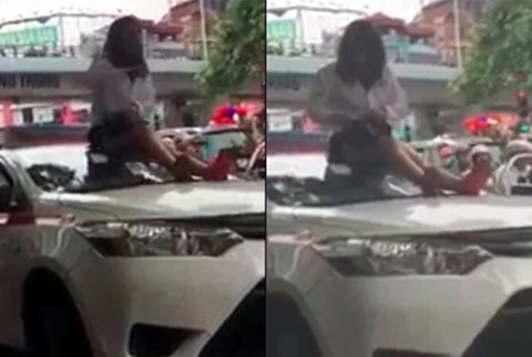 Vượt đèn đỏ bị CSGT yêu cầu dừng xe, nữ tài xế trèo lên nóc xe ăn vạ